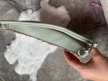 Load image into Gallery viewer, Crescent shaped, sage green purse with caribou hair tufting on moose hide.
